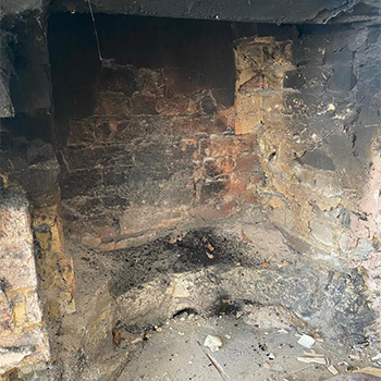 The inside of a fireplace before reconstruction