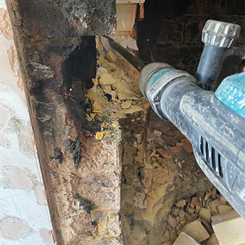 Using a jackhammer to remove pieces of an old fireplace